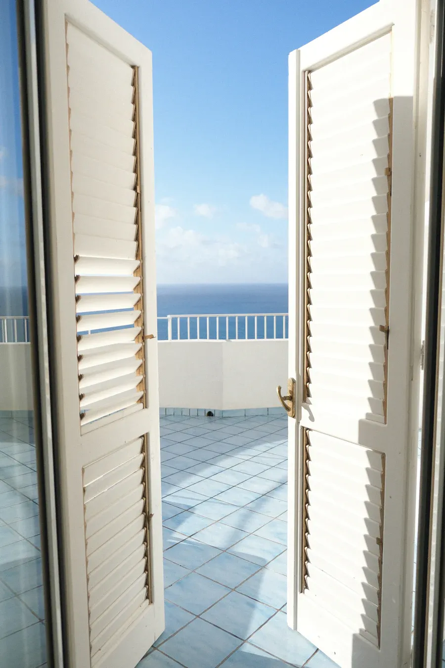 Open balcony doors onto the sea on the Amalfi Coast